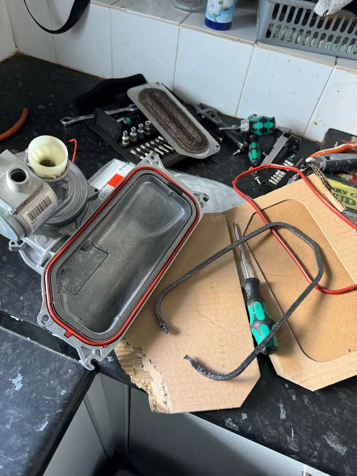 Gas Safe engineer testing boiler control components during a service